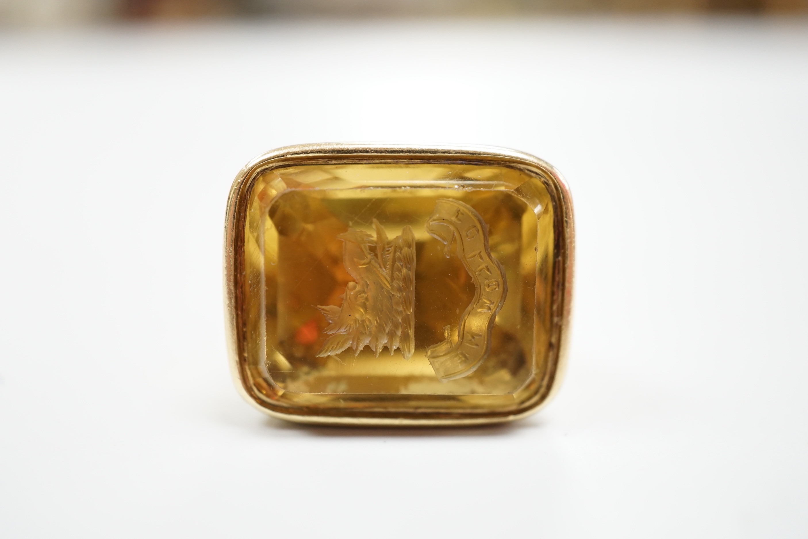 An early 19th century gold overlaid fob seal, the matrix carved with a boars head crest and motto, height 4cm